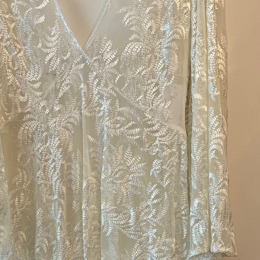 White sheer lace gown with bell sleeves